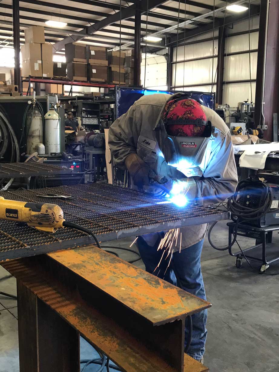 MIG welding on a grate for a process skid