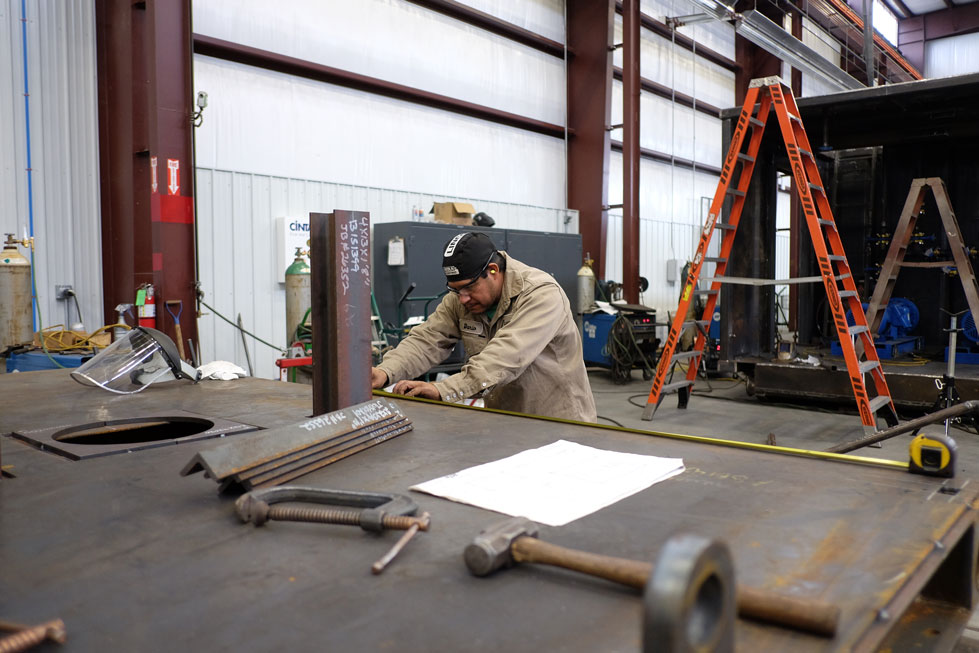 Fitter measuring fabrication project dimensions